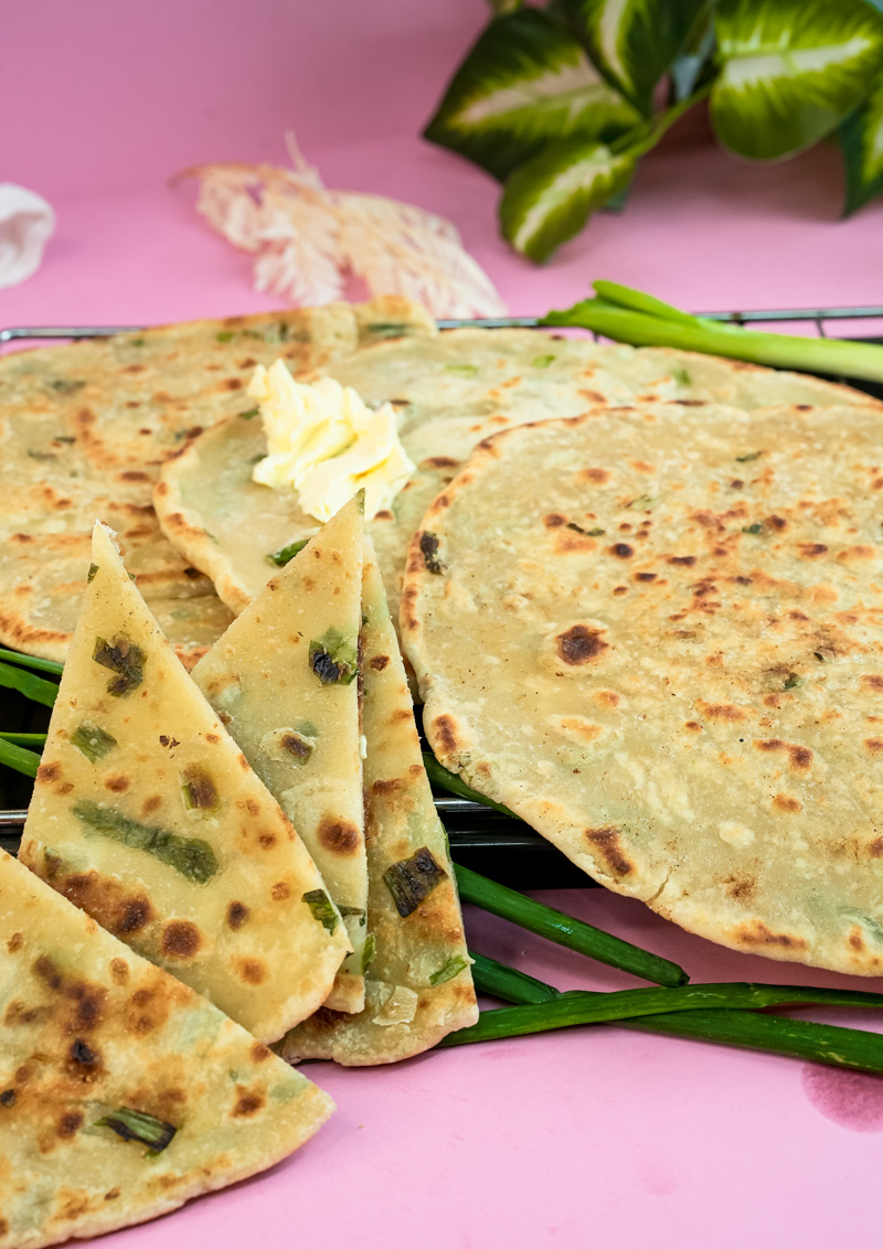Close-up of golden scallion pancakes showing flaky texture