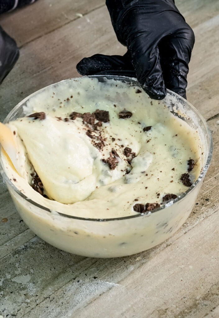 Hand mixing Oreo pancake batter with gloved hands