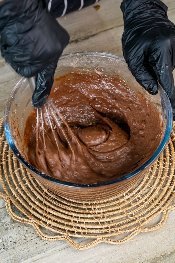 Hand mixing chocolate peanut butter muffin batter