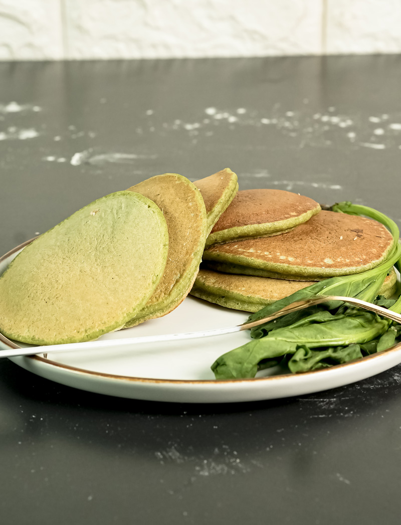 Healthy banana spinach pancakes served on white plate