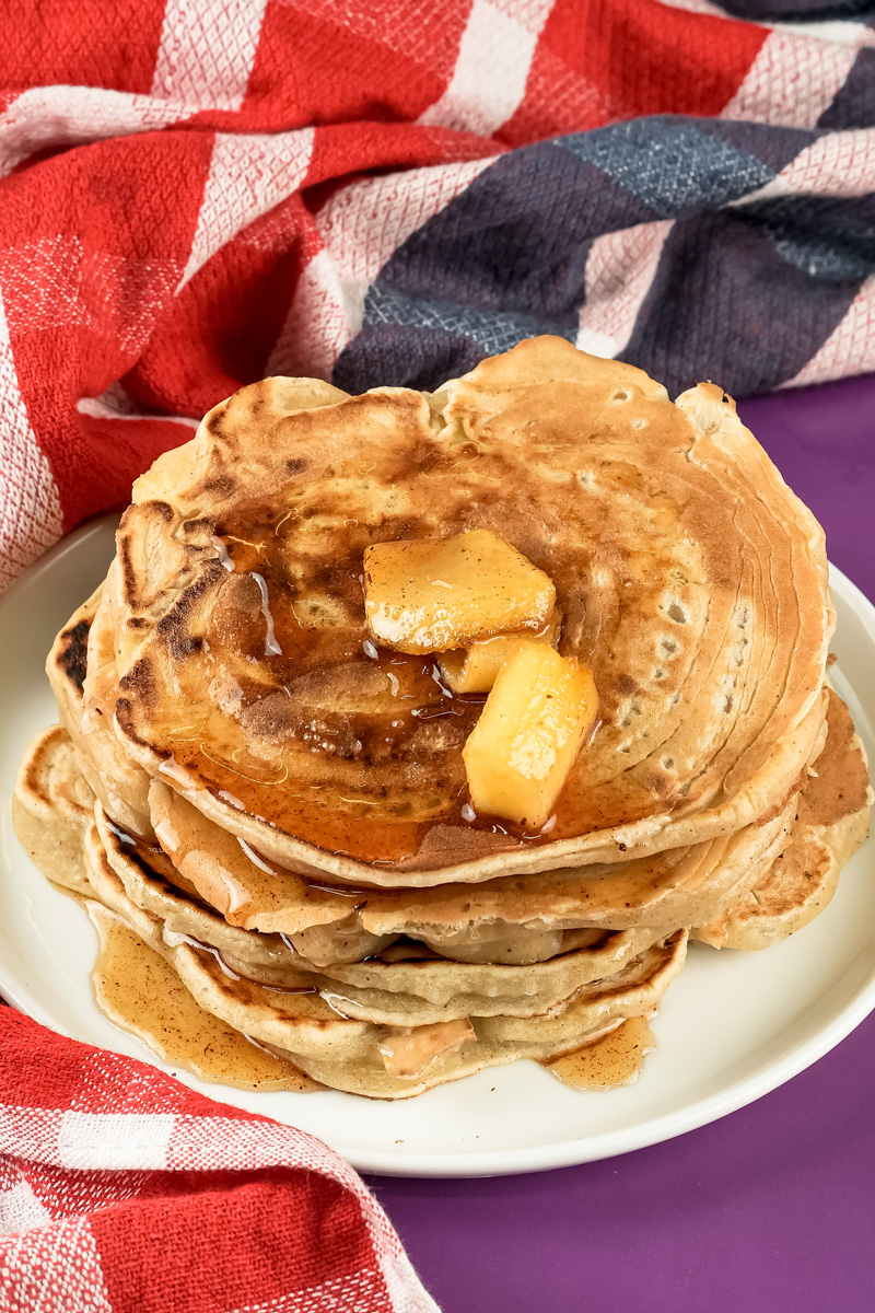 Homemade apple cinnamon pancakes with maple syrup drizzle