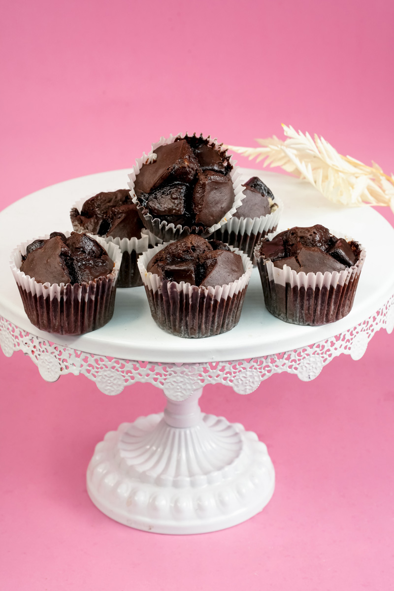 Homemade peanut butter banana muffins on lace cake pedestal