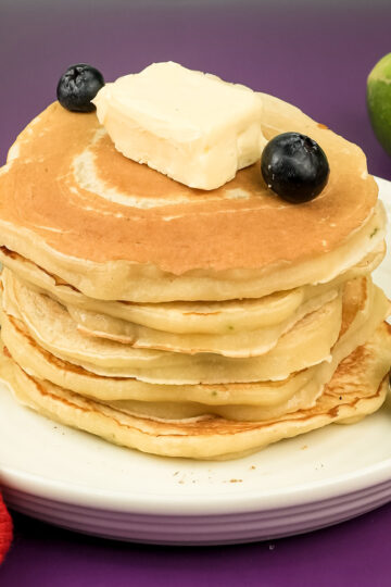 Lemon ricotta pancake stack topped with butter and fresh blueberries