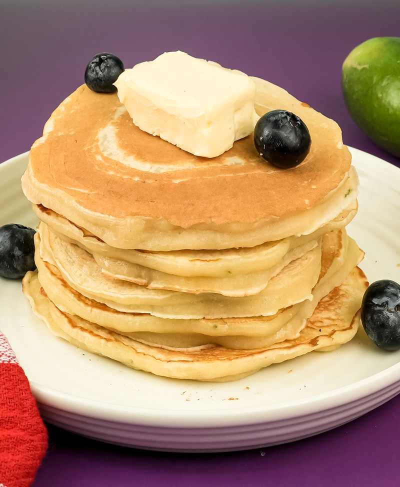 Lemon ricotta pancake stack topped with butter and fresh blueberries
