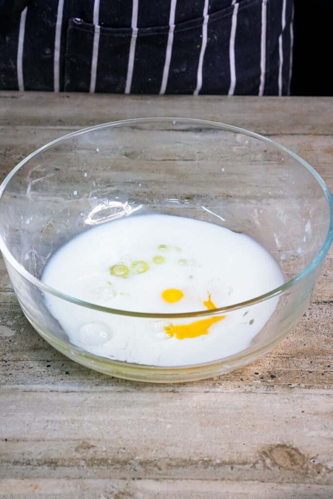 Milk and egg mixture in glass mixing bowl