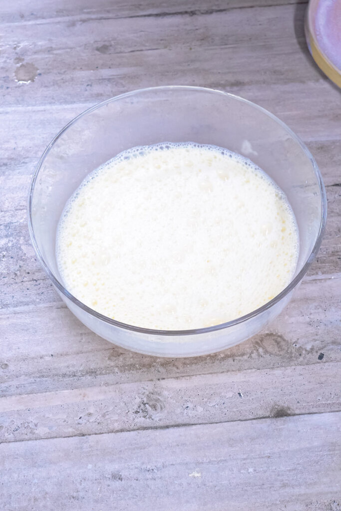 Milk in glass mixing bowl for German pancake batter