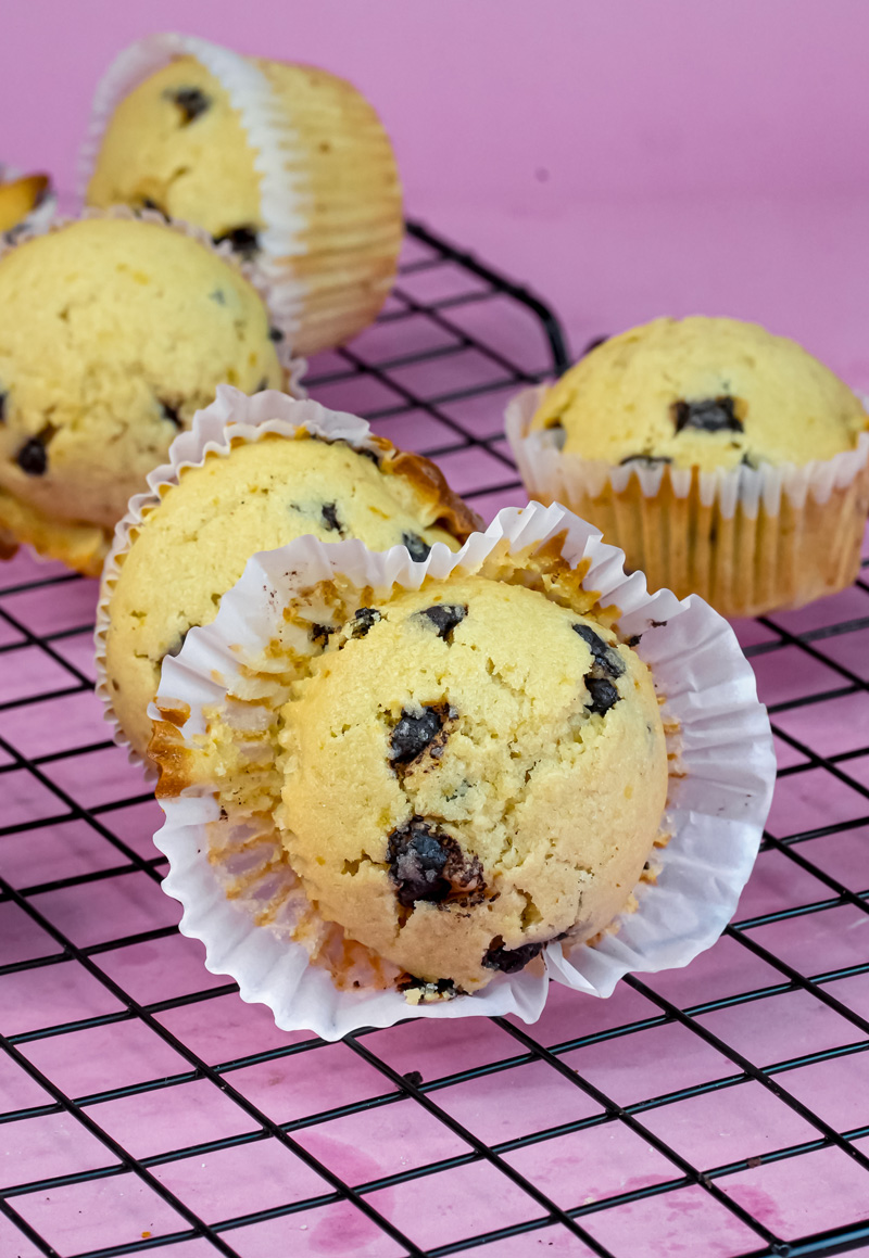 Mini chocolate chip muffin cut in half showing fluffy texture on cooling rack