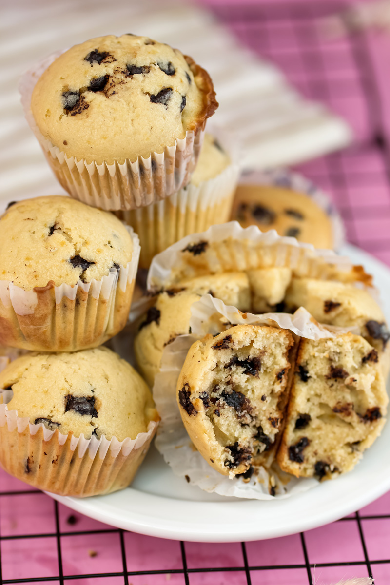 Mini chocolate chip muffins with broken muffin showing soft interior