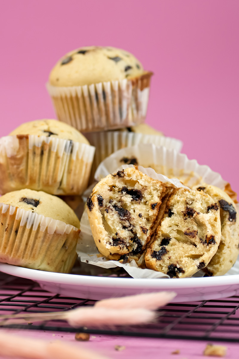 Mini chocolate chip muffins with halved muffin on white plate