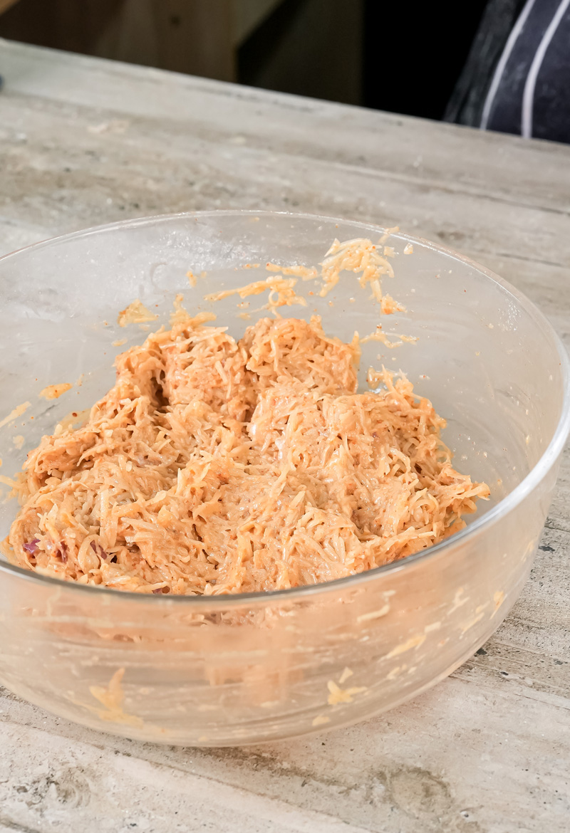 Mixed potato pancake batter in glass bowl