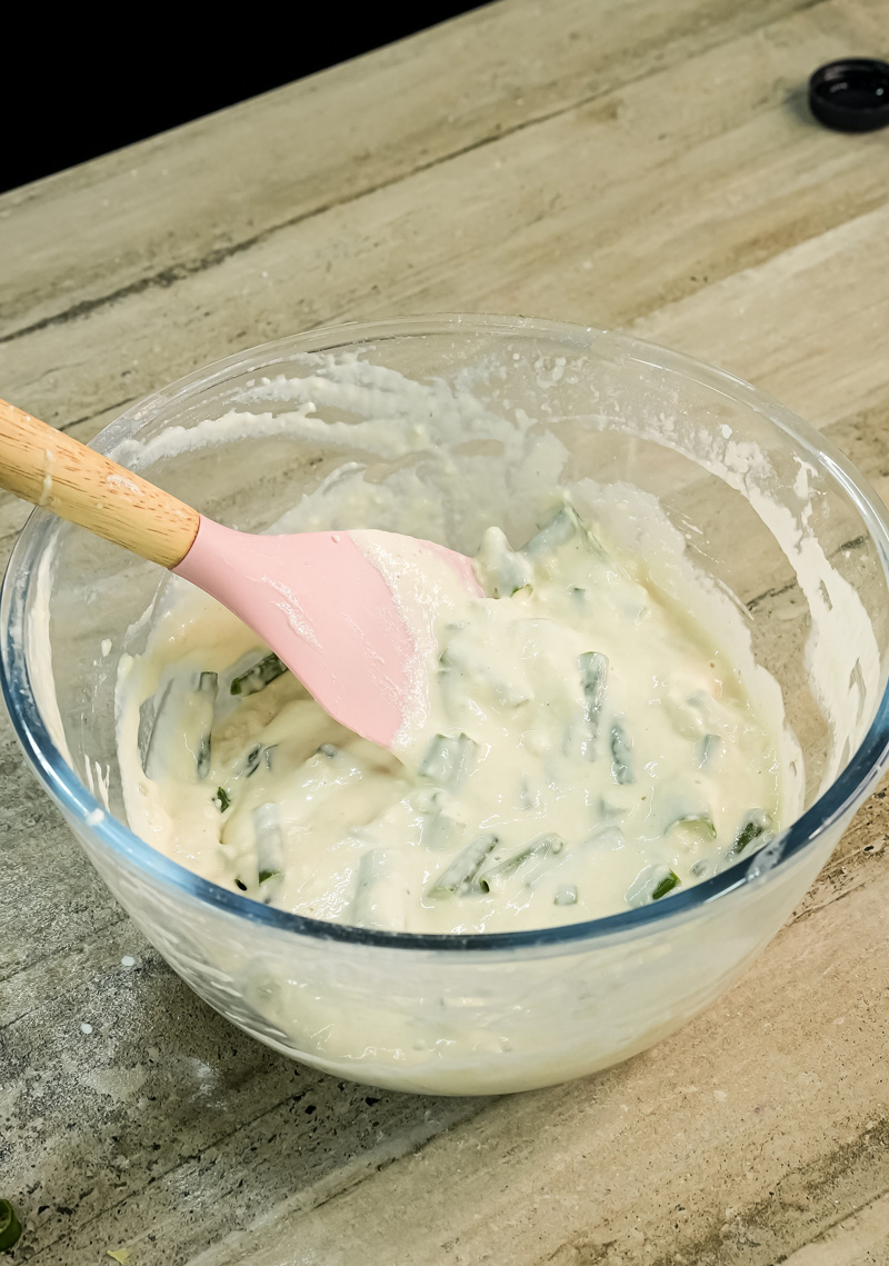 Mixing Korean scallion pancake batter with pink spatula
