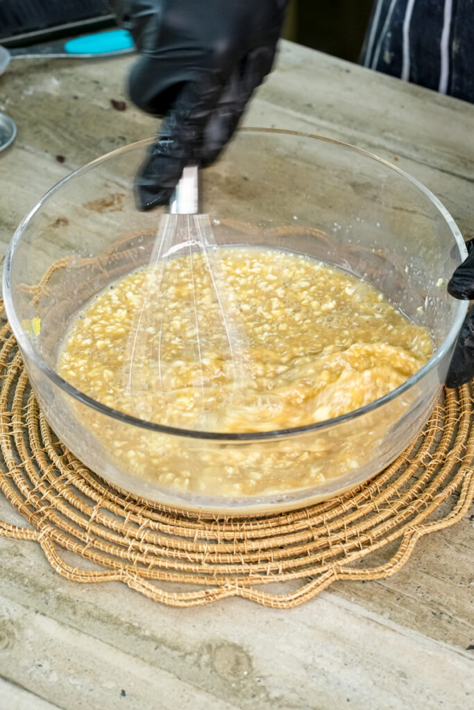 Mixing mini chocolate chip muffin batter with hand mixer