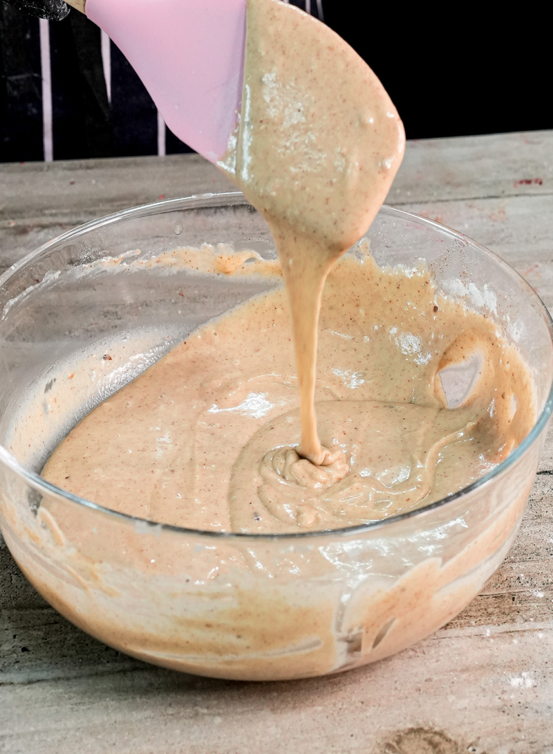 Mixing peanut butter pancake batter with pink spatula