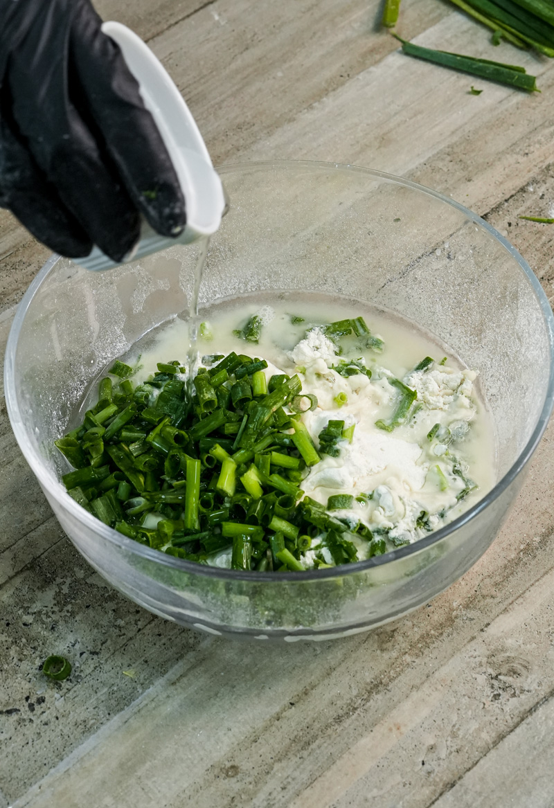 Mixing scallion pancake dough ingredients in glass bowl