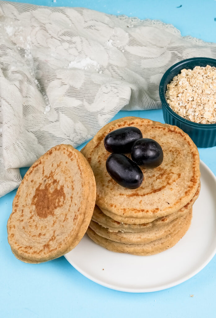 Oat pancakes topped with fresh dates and oats