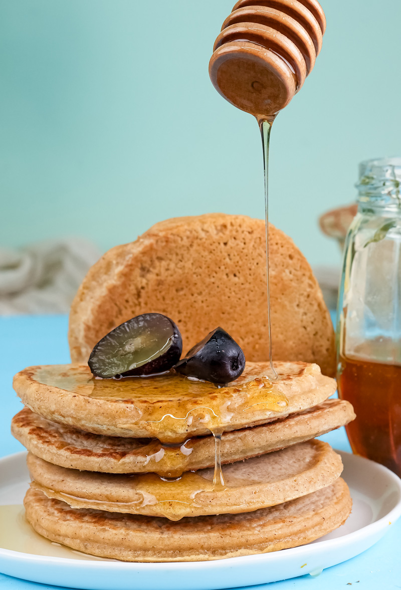 Fluffy oat pancakes with honey drizzle and fresh dates