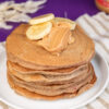 Breakfast stack of peanut butter pancakes with banana topping