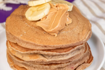 Breakfast stack of peanut butter pancakes with banana topping