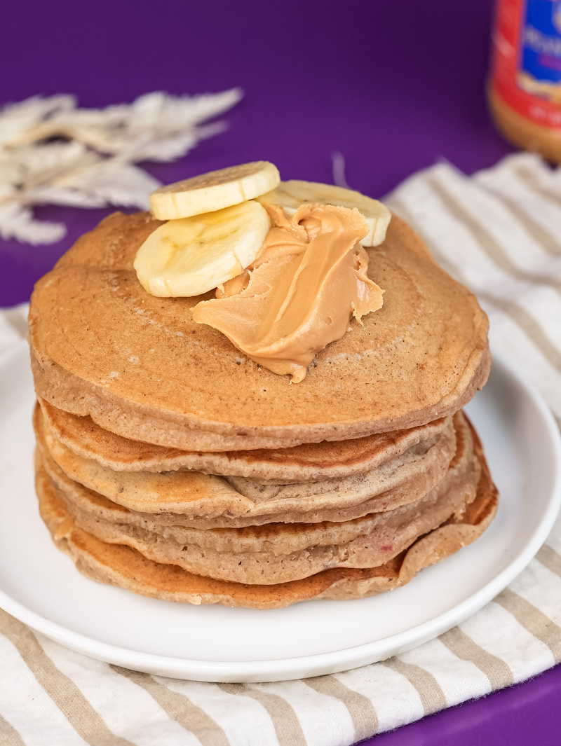 Breakfast stack of peanut butter pancakes with banana topping