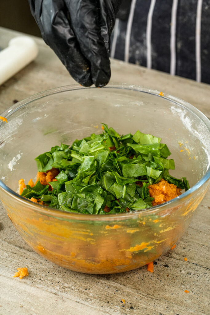 Pizza muffin ingredients in bowl with fresh greens and vegetables