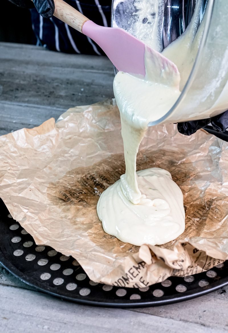 Pouring German Apple Pancake batter into parchment-lined skillet