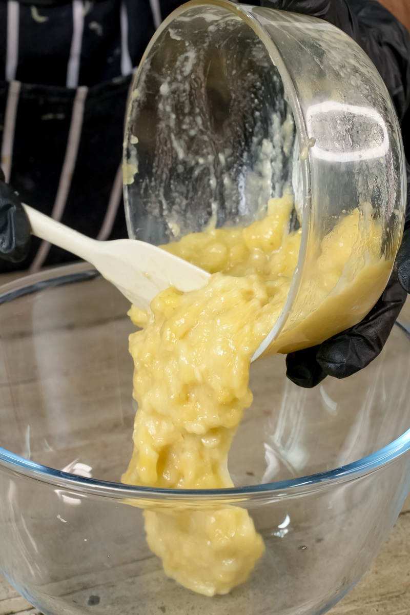 Pouring mashed bananas from blender into mixing bowl