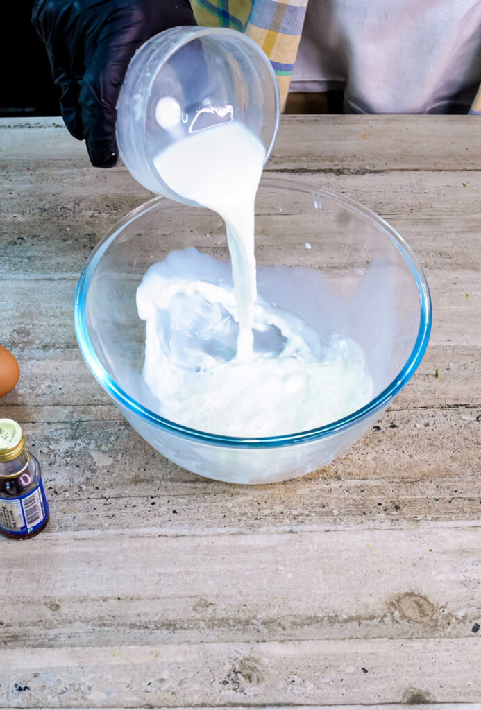 Pouring milk into mixing bowl for lemon ricotta pancake batter