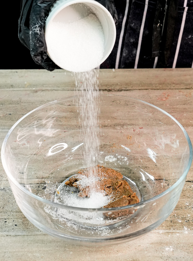 Pouring milk into peanut butter mixture for pancake batter