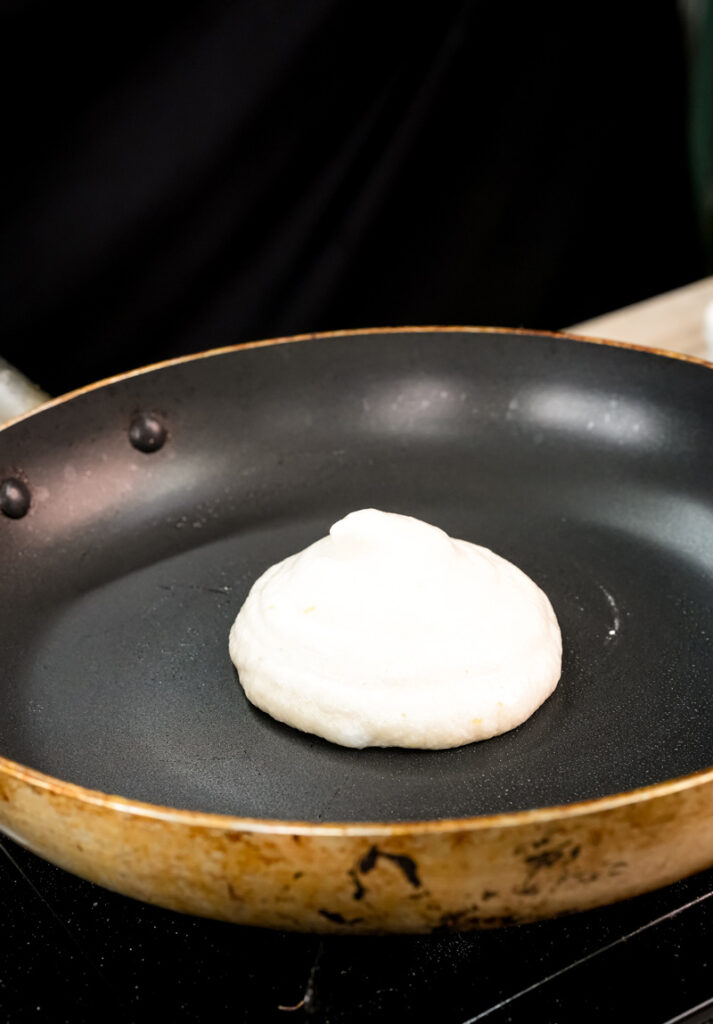 Raw Japanese pancake batter in non-stick pan