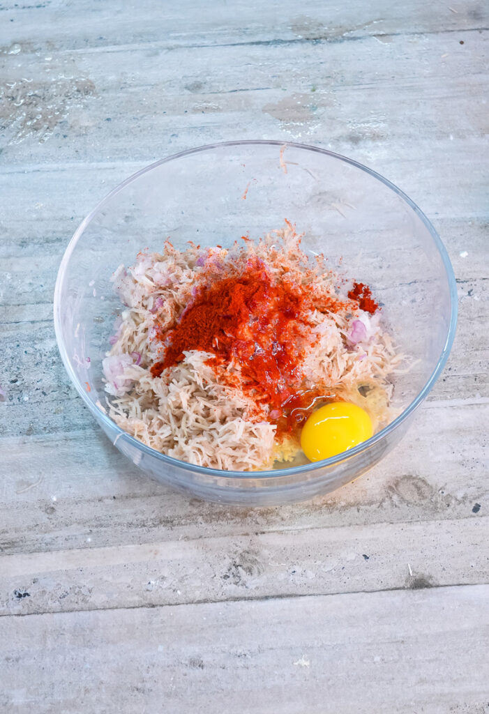 Raw egg added to seasoned potato pancake batter