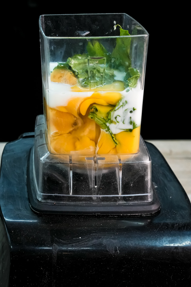 Raw ingredients in blender for banana spinach pancakes