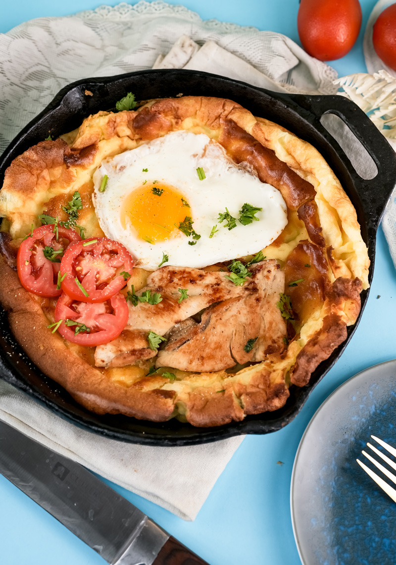 Savory Dutch baby pancake topped with chicken and fried egg
