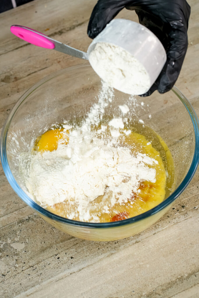 Sifting flour into muffin batter