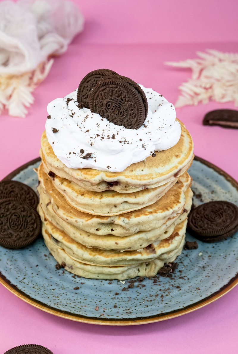 Stack of Oreo pancakes with whipped cream and Oreo cookie topping