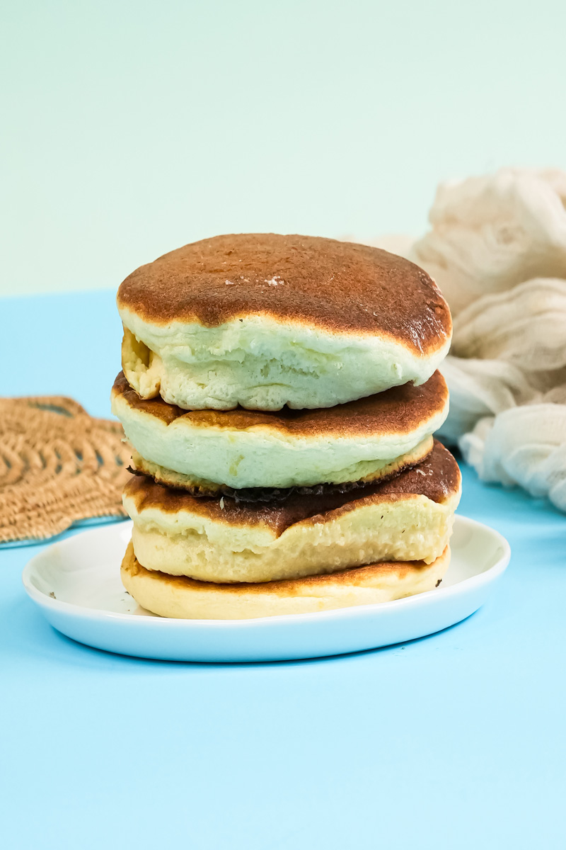 Stack of fluffy Japanese pancakes on white plate