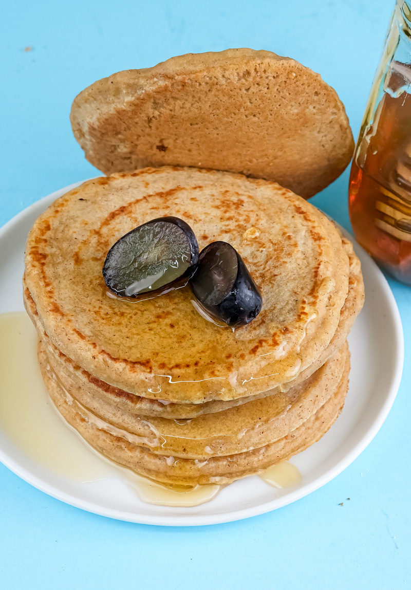 Oat pancake tower with natural honey and fruit garnish