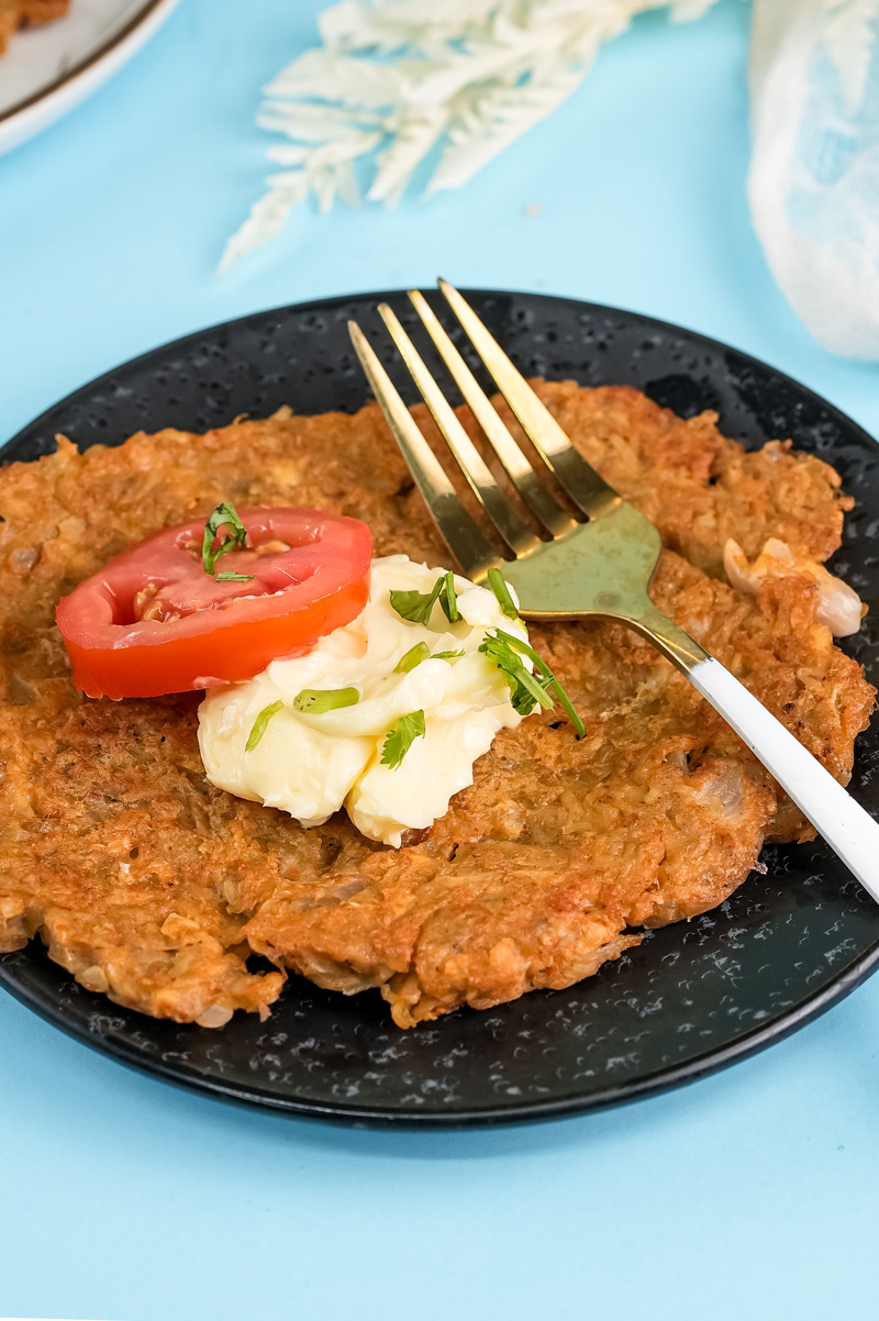 Traditional German potato pancake with tomato slice garnish