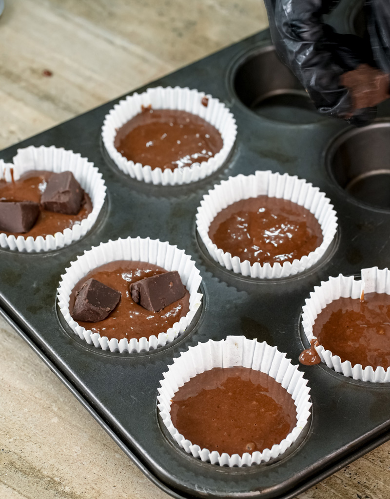 Unbaked peanut butter banana muffins with chocolate chips in tin
