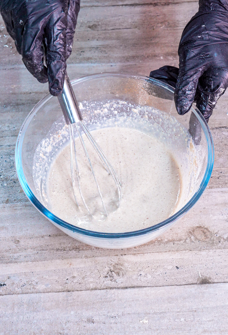 Whisking oat pancake batter until smooth