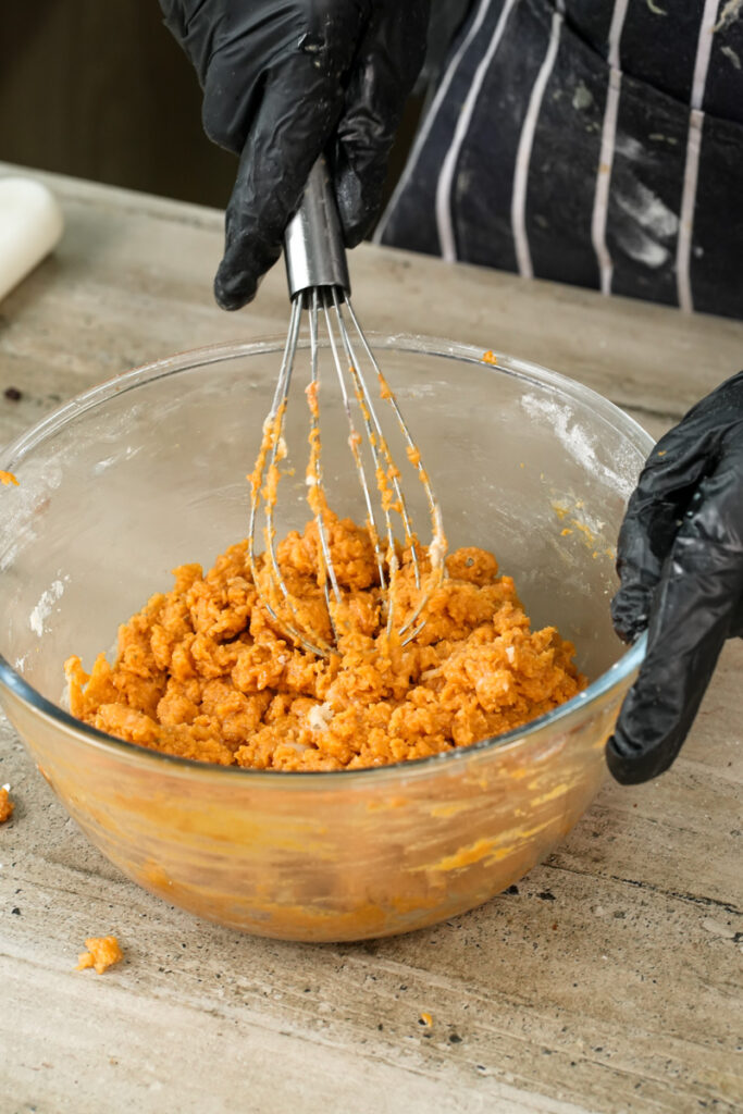 Whisking orange pizza muffin batter until combined