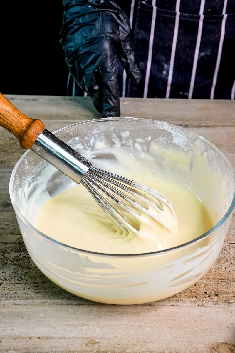 Whisking silver dollar pancake batter until smooth in glass bowl