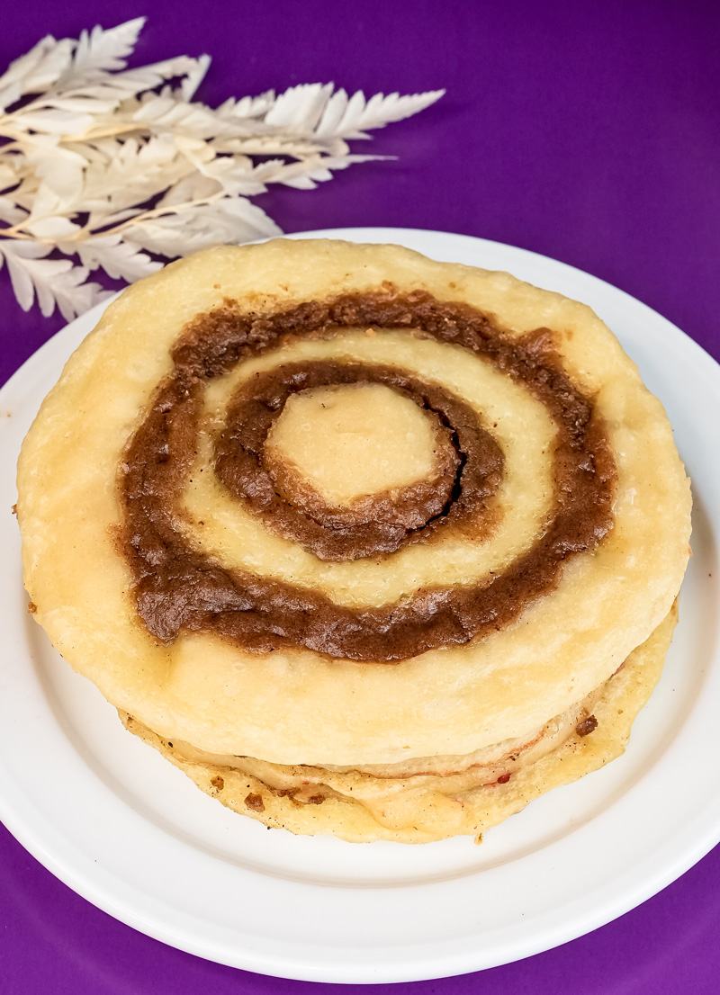 Top view of golden cinnamon roll pancake with distinct spiral swirls