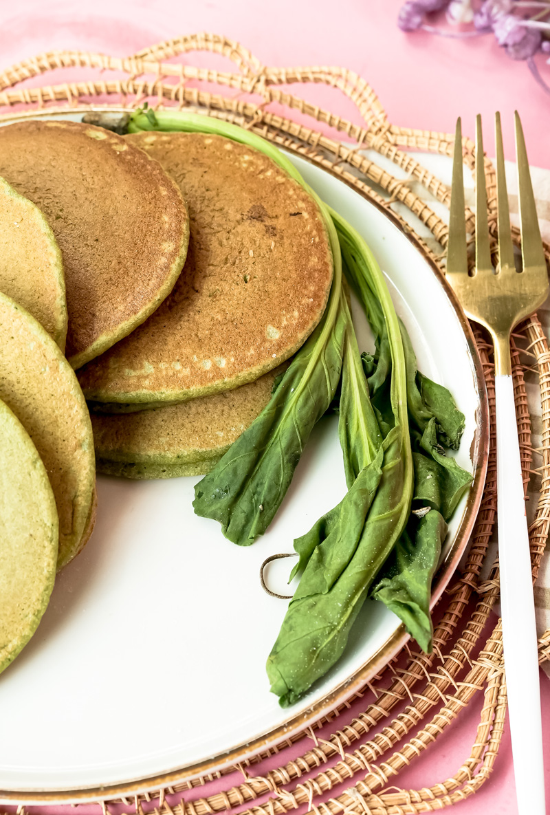 Close-up of green banana spinach pancakes with spinach leave