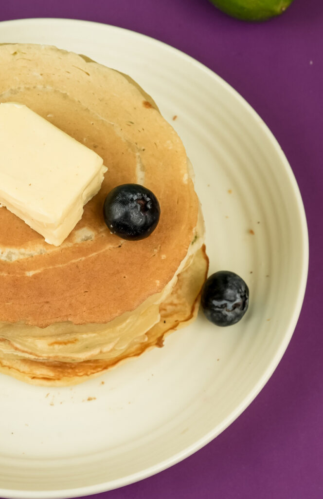 Close-up of lemon ricotta pancake with melted butter and blueberry