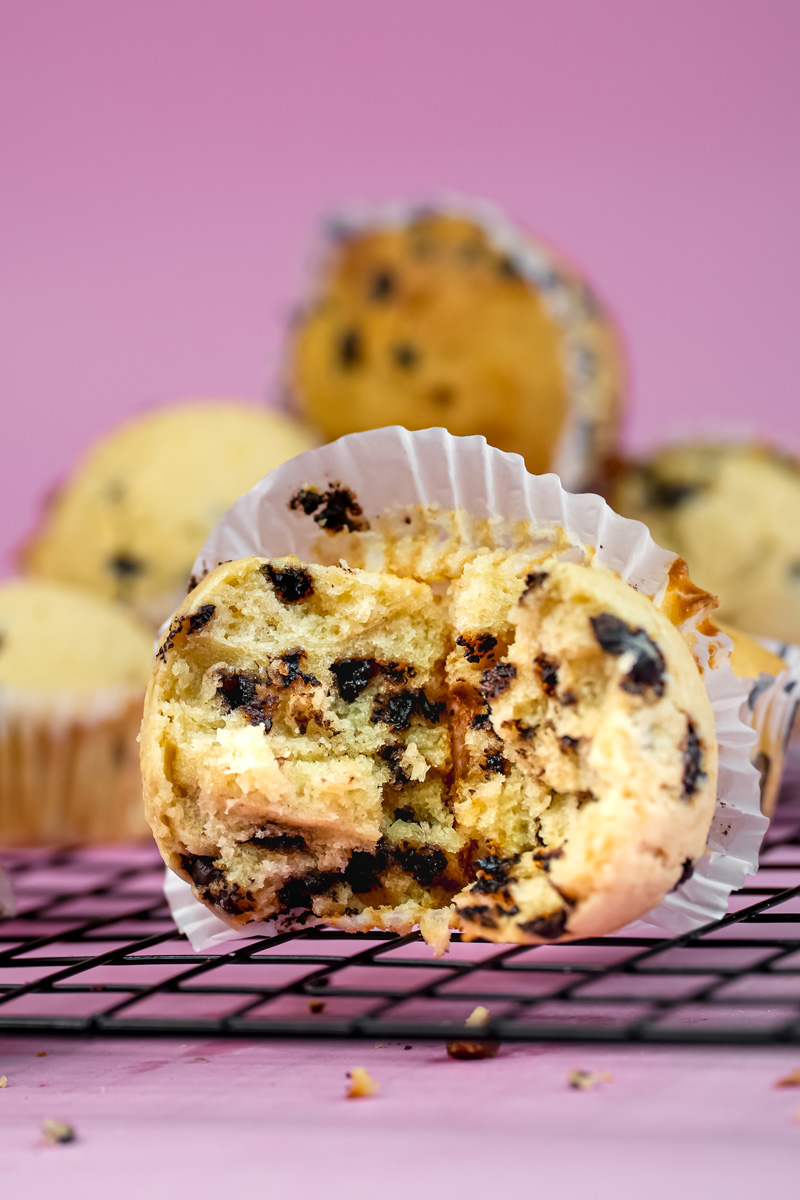 Split mini chocolate chip muffin displaying interior texture and chocolate chips