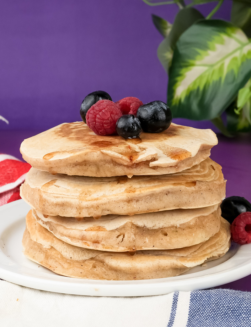 Finished silver dollar pancakes with honey syrup and berry topping